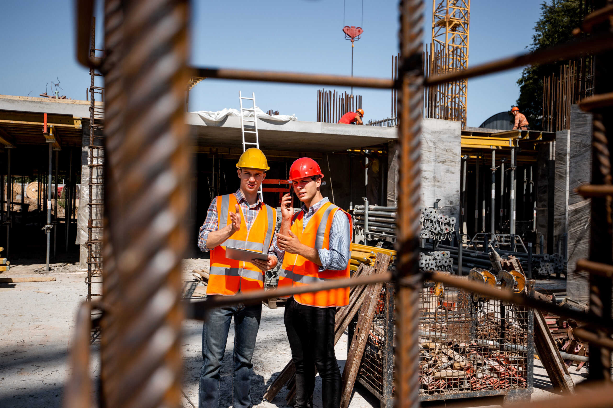 Two construction workers on a building site.