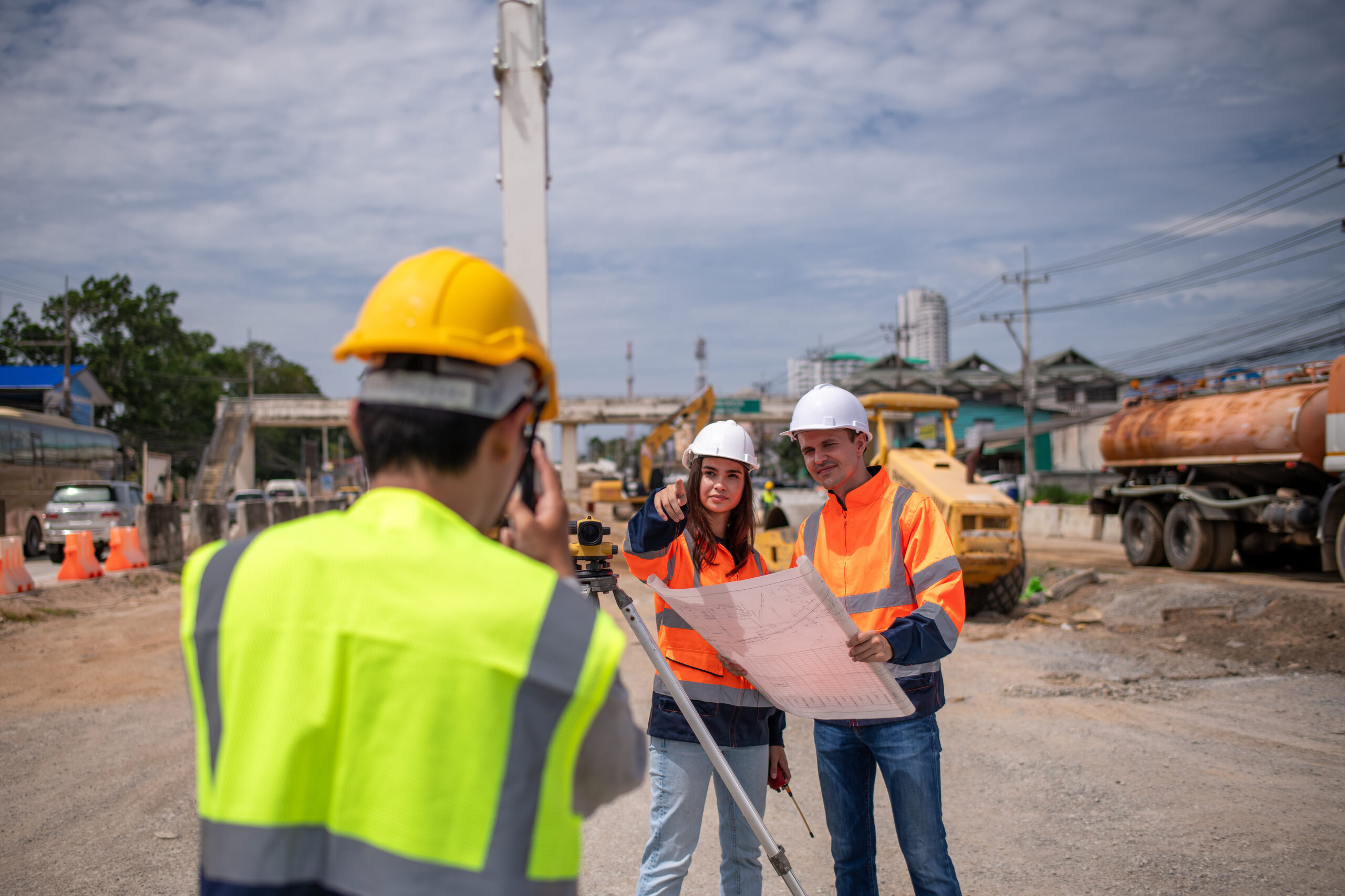 Engineers discussing plans on a construction site.